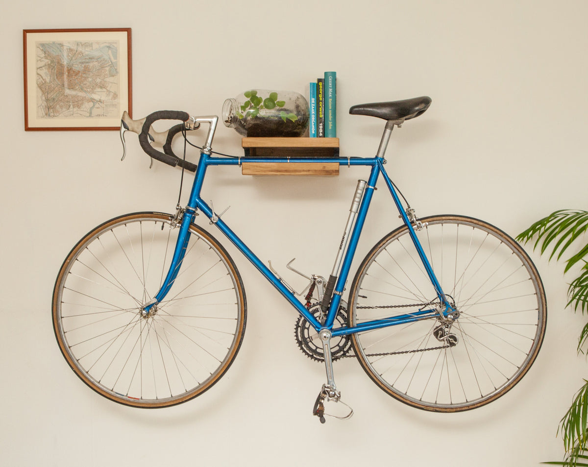 Oak Bike Wall Hanger #1 with natural oil finish, styled with plants and decor on top