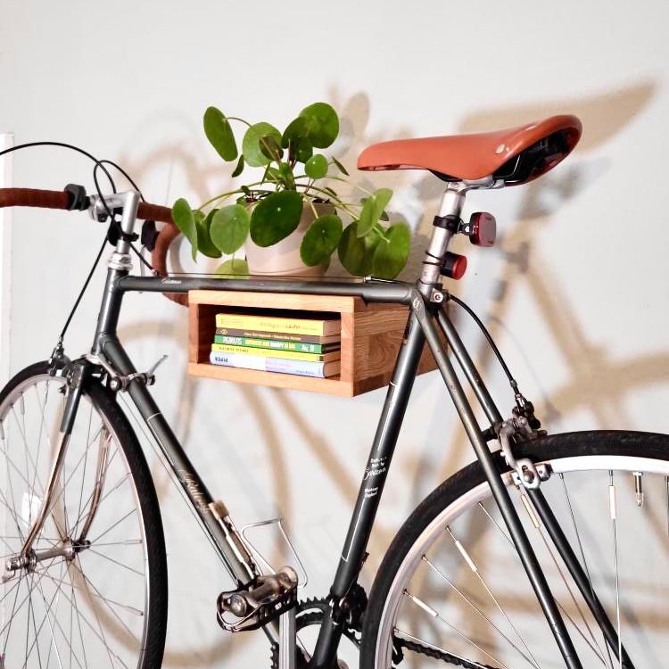 A picture of a bike mounted on a wooden Bike Wall mount