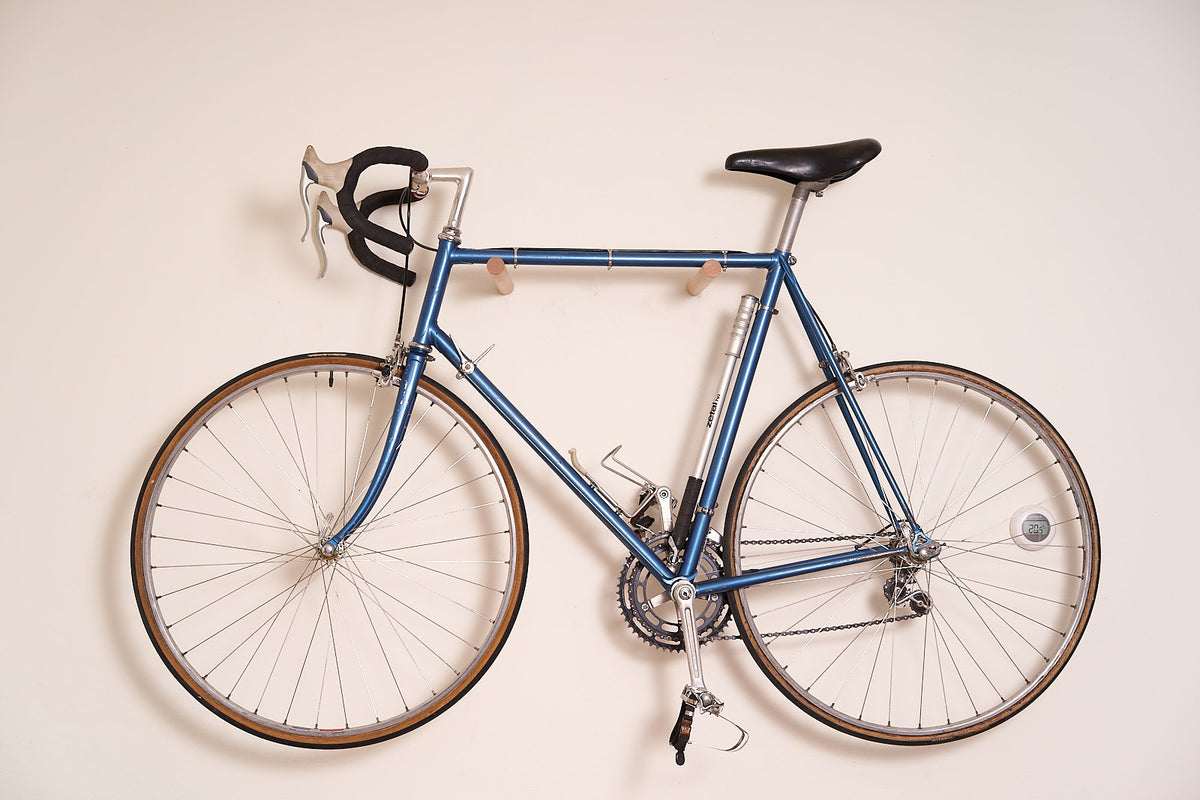 Road bike mounted on the oiled beech Bike Wall Hanger #3 at home