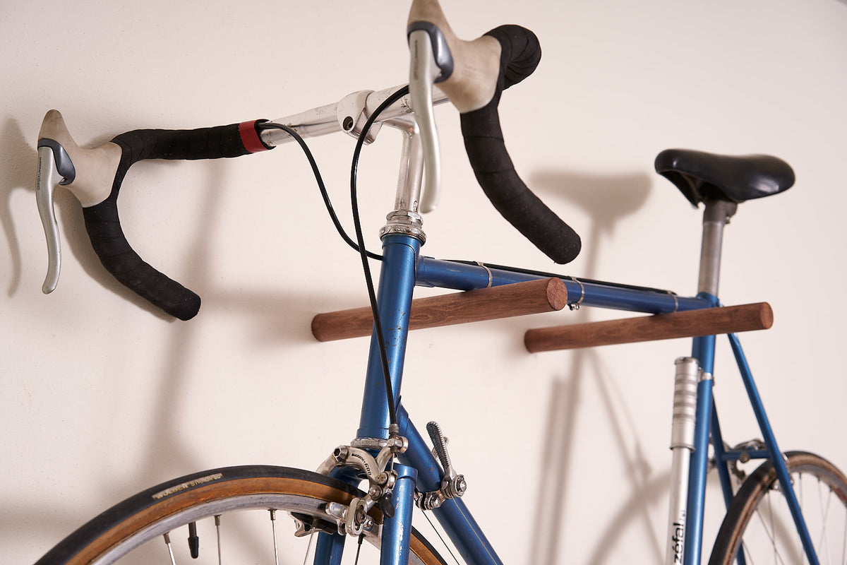 Road bike mounted on the smoked beech Bike Wall Hanger #3 at home